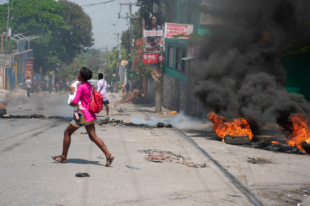 woman carrying a child, Port-au-Prince, Haiti